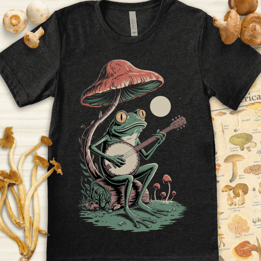 Illustration of a frog playing a banjo under a large mushroom with a full moon in the background, surrounded by smaller mushrooms and grass.