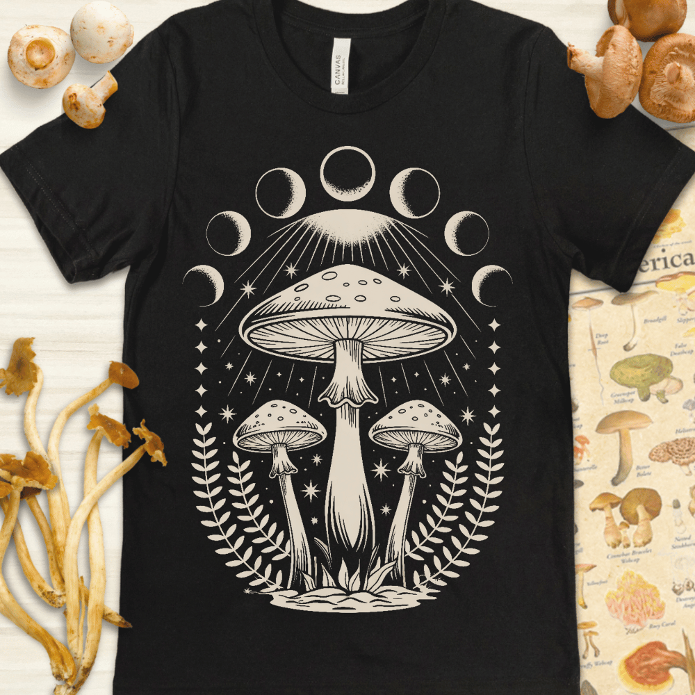 Cream-colored illustration of three mushrooms under moon phases, surrounded by stars and fern leaves in a celestial, symmetrical design.