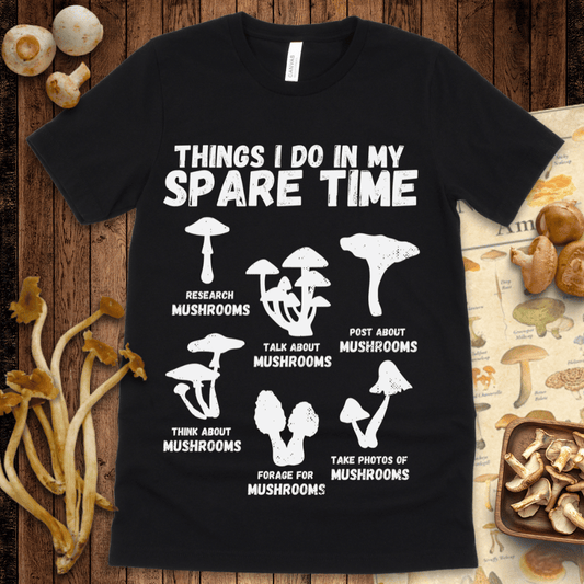 Funny graphic t-shirt showing mushroom silhouettes with text reading “Things I Do In My Spare Time” and six mushroom-related activities