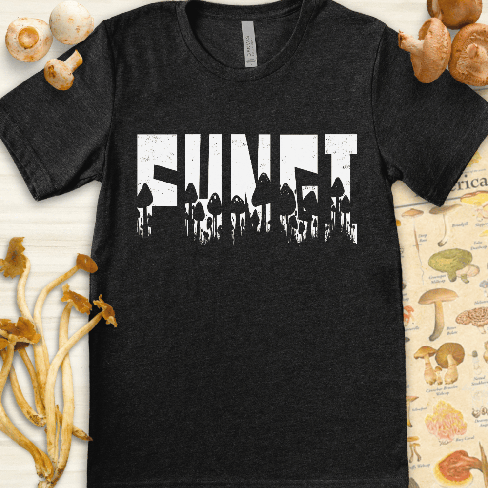Black and white graphic T-shirt design featuring the word "FUNGI" filled with silhouettes of various mushroom species beneath it.