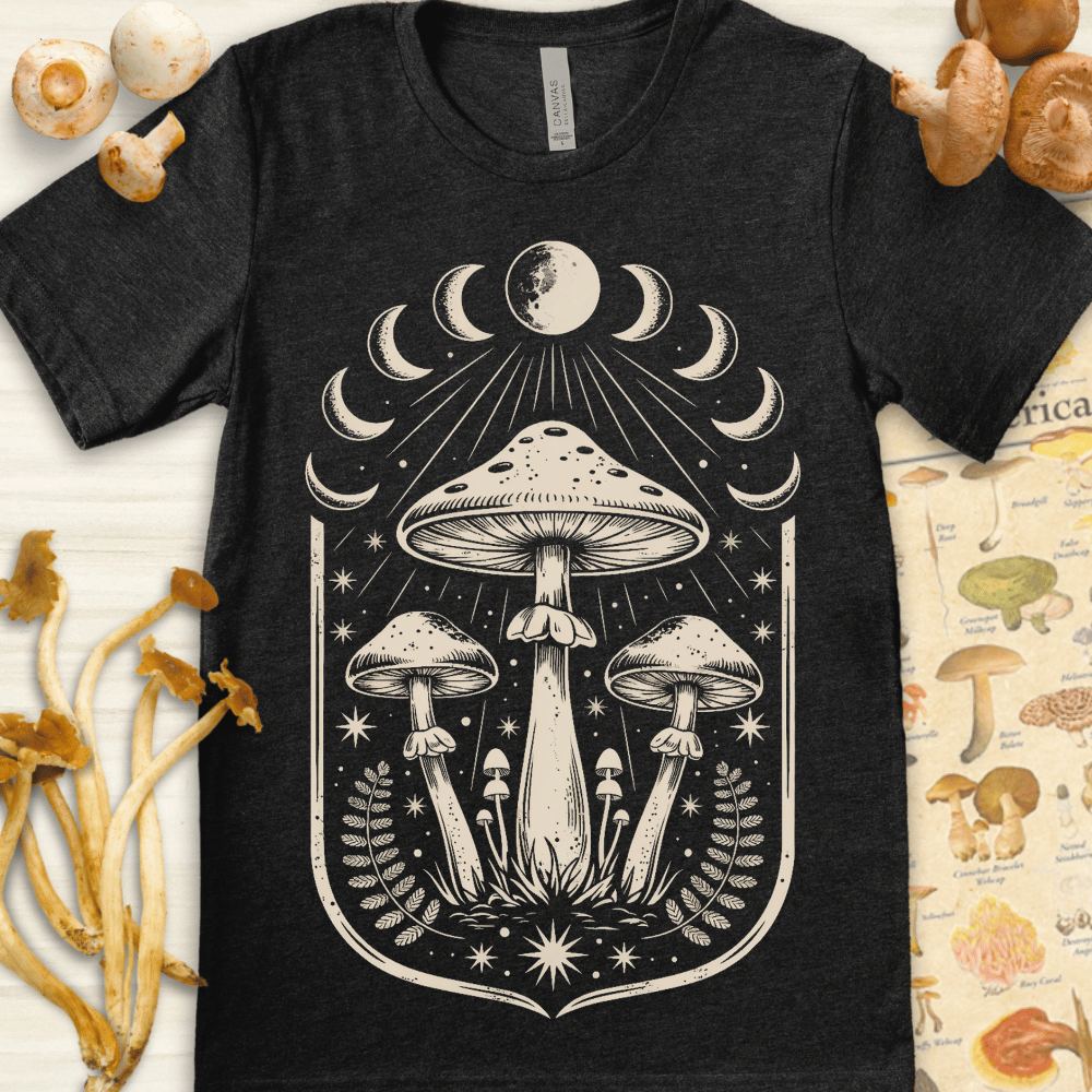 Cream-on-black design of tall mushrooms under moon phases with stars and ferns in a symmetrical, celestial layout.