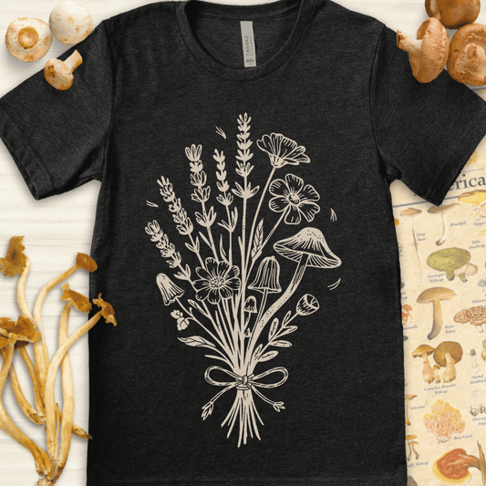Hand-drawn vintage-style illustration of a bouquet with wildflowers and mushrooms tied together with a ribbon on a black background.